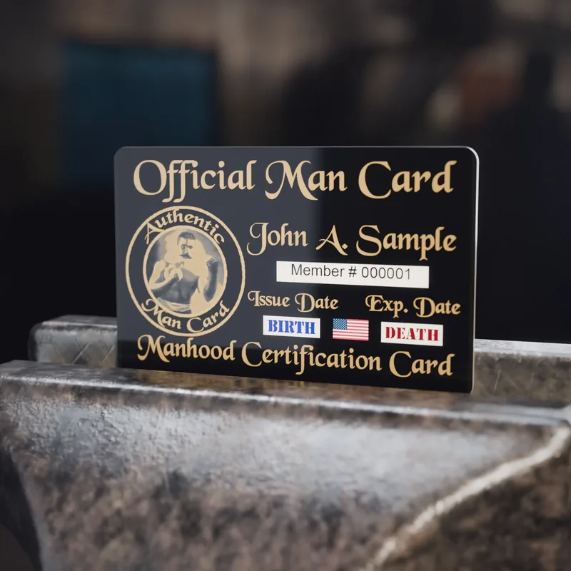 The Authentic Man Card standing on an anvil in a workshop